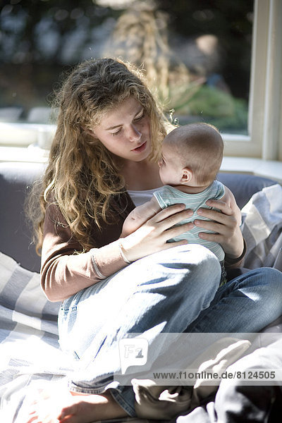Europe Holland Netherlands 14-15 Years 6-7 Months Affectionate Baby Girls Indoors Kissing Teenage Girl Two People Bonding Care Love Togetherness Close-up Color Image Photography