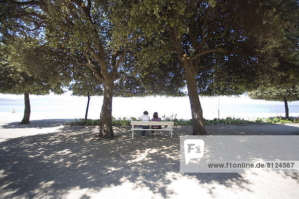 Travel Destination Zadar park croatia dalmatia riva togetherness idyllic love two people waterfront shade trees sunny mediterranean