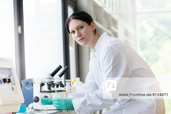 Portrait of female scientist using laboratory equipment