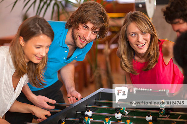 Close up of friends having fun playing table football