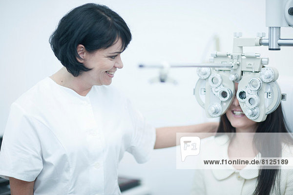 Junge Frau beim Optiker mit Sehtest