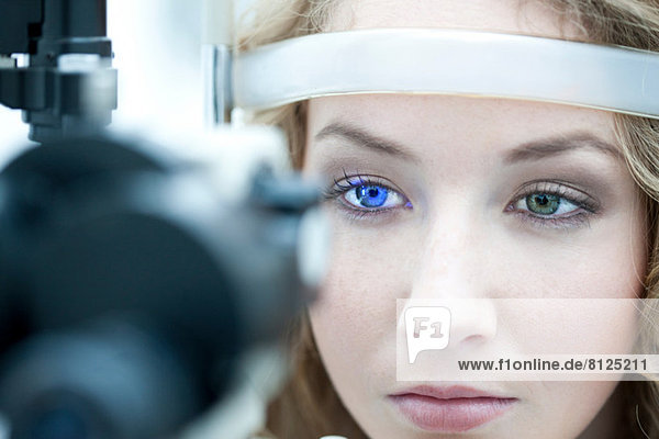Close up of young woman having eye examination