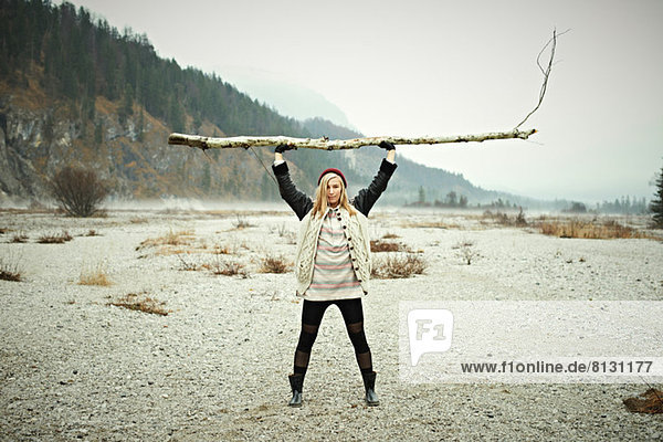 Woman holding log