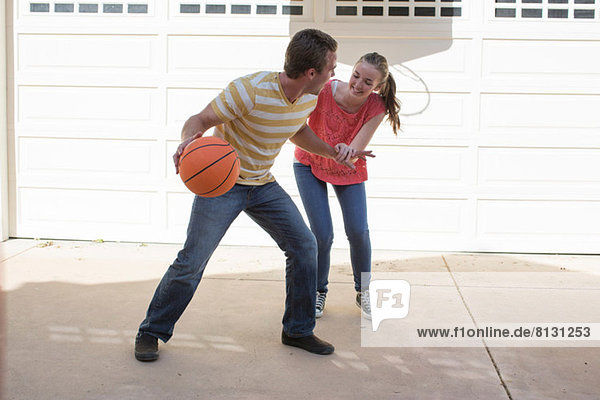 Brother and sister playing basketball