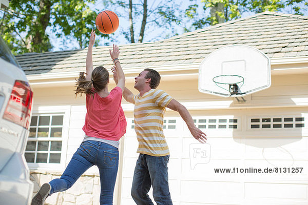 Brother and sister playing basketball