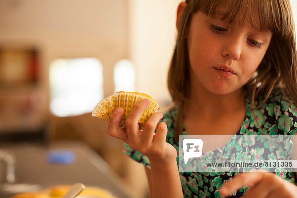 Sad girl holding cupcake