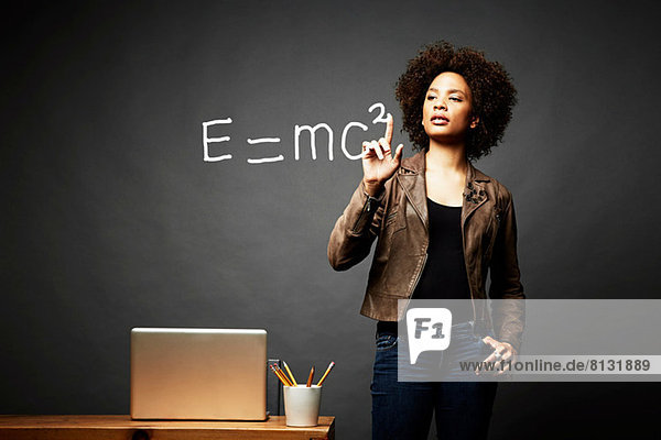 Woman solving mathematical equation