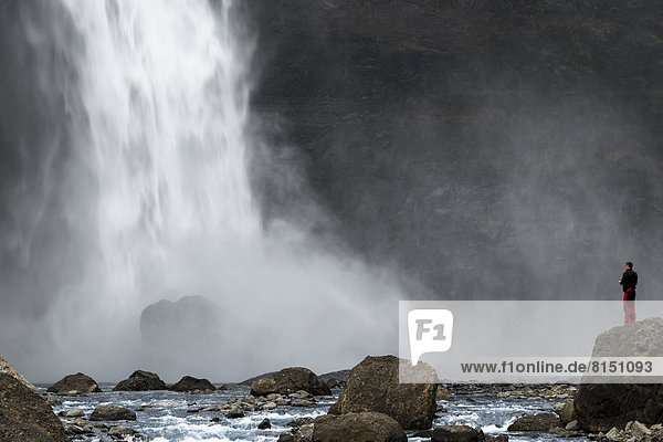 Tourist steht am Wasserfall Haífoss am Fluss Fossá í Thjósárdal