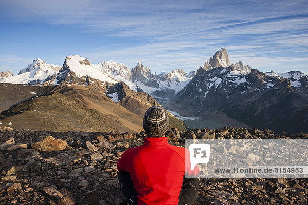 Hiker at the Loma del Pliegue Tumbado  views of Cerro Torre and the Fitz Roy massif