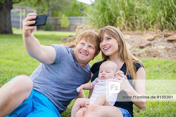 Family taking picture of themselves  smiling