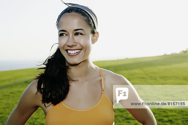 Hispanic woman smiling in field