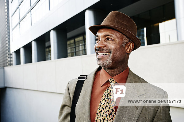 Black businessman standing on city street