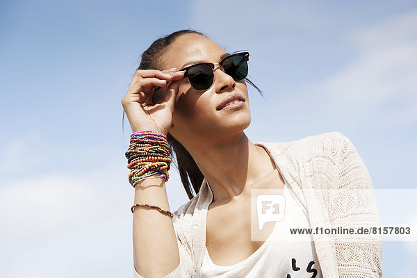 Germany  Young woman with sunglasses  smiling