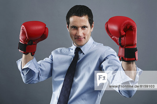 Portrait of mature man wearing boxing glove  smiling