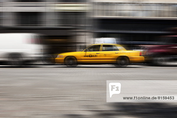 USA  New York  Blick auf gelbes Taxi in Bewegung