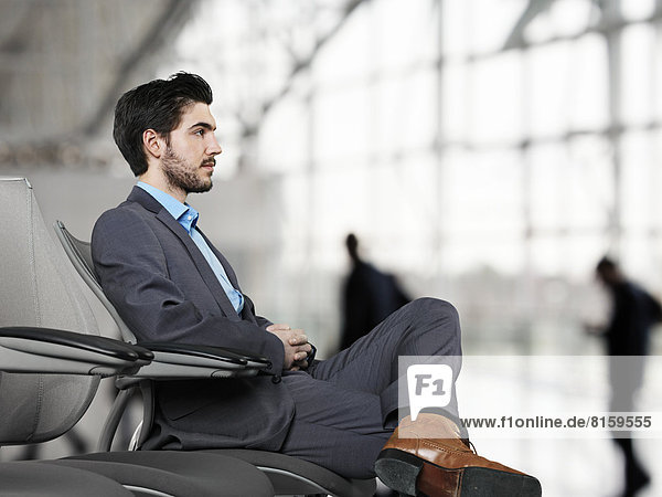 Businessman waiting at airport  looking away