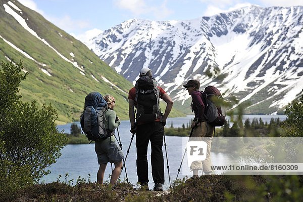 Backpacker hiking at Crescent Lake in Chugach National Forest Southcentral Alaska.