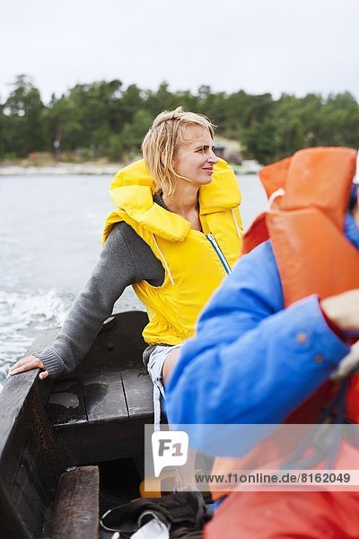 Woman in life vest on boat