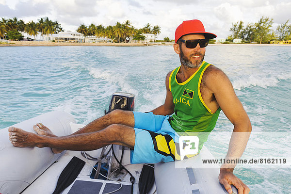 Smiling man sitting on motorboat