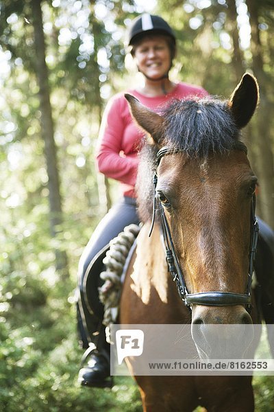 Mature woman on horse
