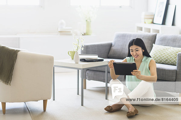 Woman using tablet pc at home