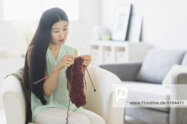 Woman knitting at home
