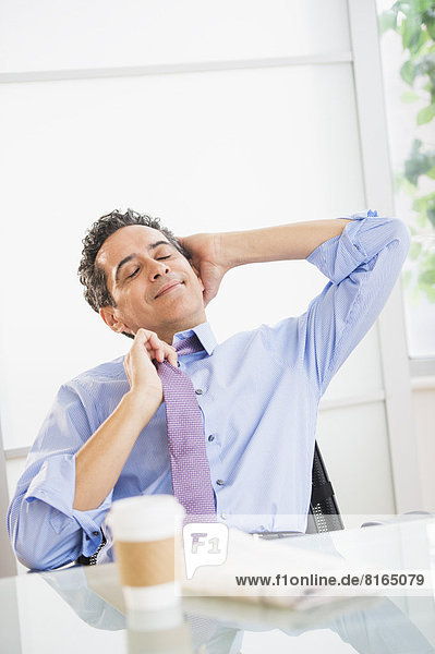 View of mature man relaxing in office