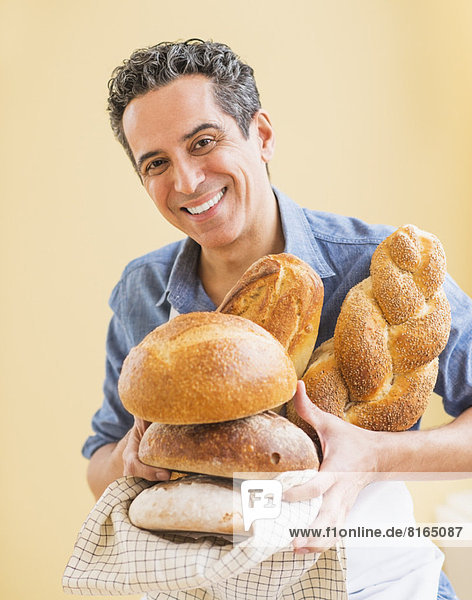 Studio shot of baker holding bread