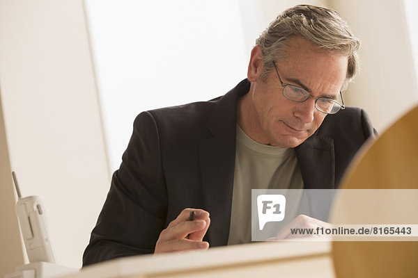 Mature business man concentrating on work