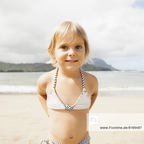 Baby girl (2-3) on beach