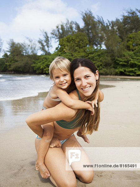 Mother with daughter (2-3) on beach