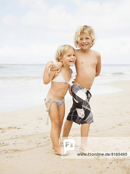 Laughing sibling on beach