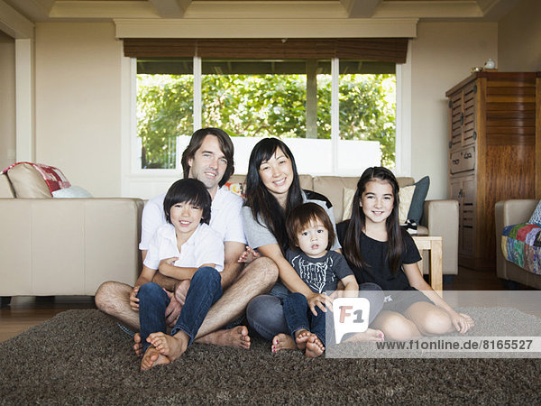 Portrait of family sitting in living room