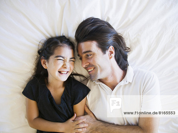Father with daughter (8-9) laughing