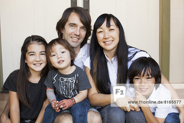 Portrait of family with three kids (2-3  8-9)