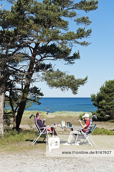 Family enjoying picnic at seaside