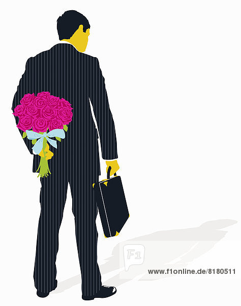 Businessman with briefcase hiding bouquet of flowers behind back