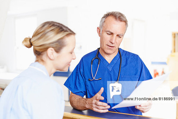 Doctor and nurse looking at notes