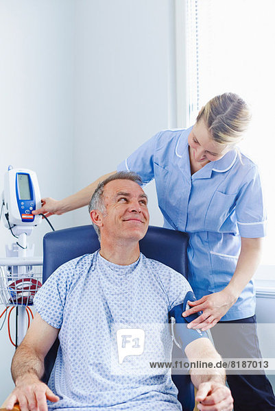 Nurse taking patient's blood pressure