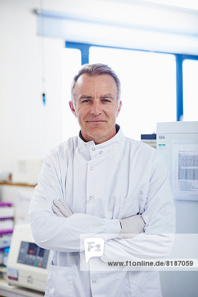 Portrait of researcher standing in lab wearing lab coat