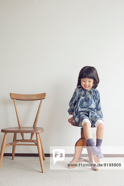 Girl sitting on stool  portrait