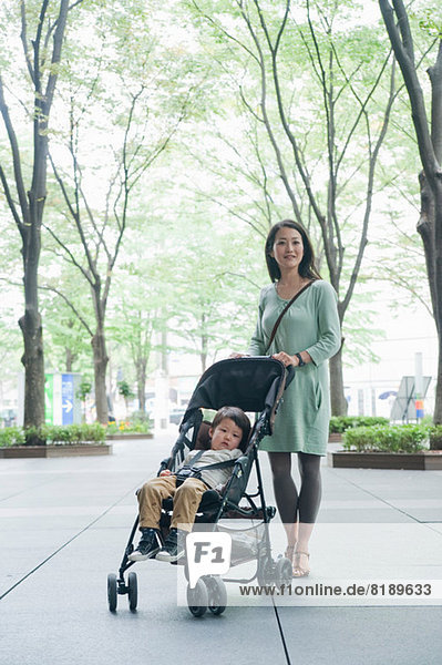 Mother with son sitting in stroller  portrait
