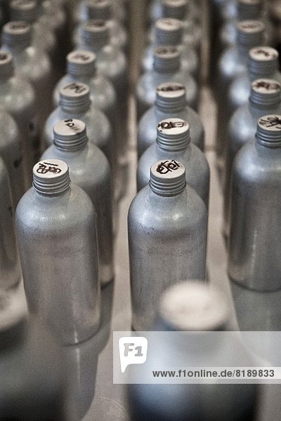 Rows of Metal Bottles with French Writing