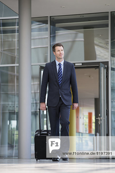 Germany  Hannover  Businessman walking with briefcase at terminal