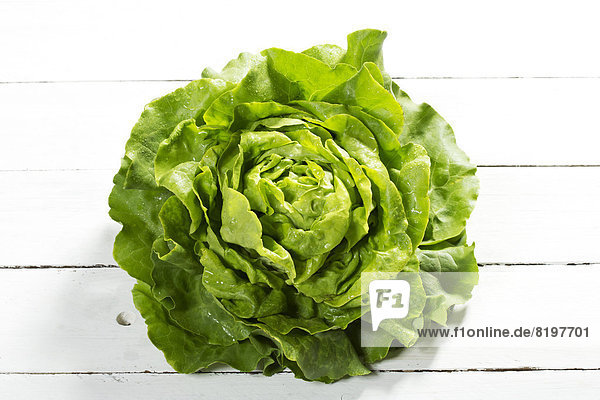 Green lettuce salad on wooden table  close up