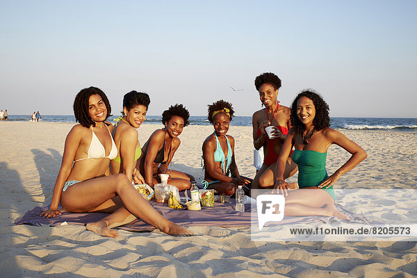 Women relaxing together on beach