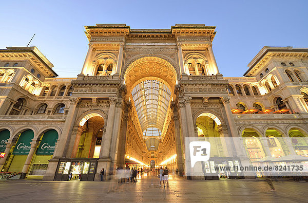 Triumphal Arch to the Cathedral Square  entrance to the luxury shopping arcade  roofed gallery of Galleria Vittorio Emanuele II  twilight shot at the blue hour