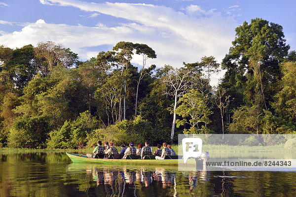 Tourist group travelling by boat through the rainforest
