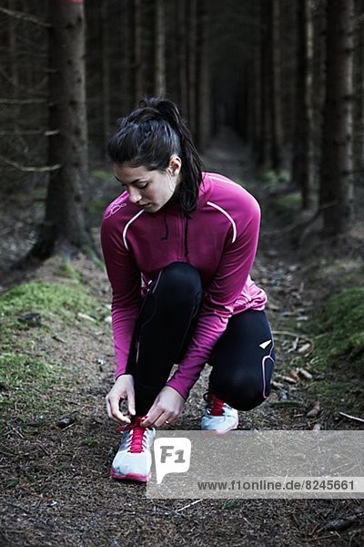 Woman runner tying shoelaces