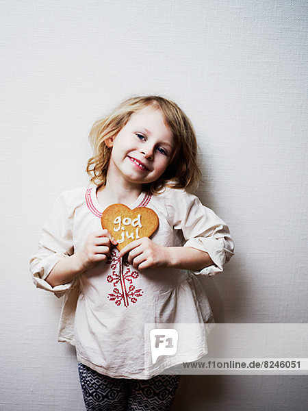 Girl holding Christmas gingerbread